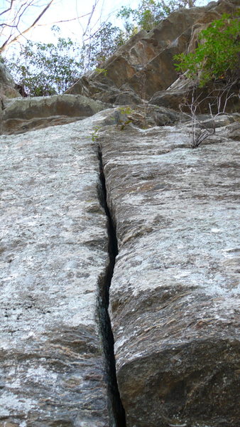 The hand crack start to Whitewater Crack. Exit to the right under the roof, or out a bushwack to the left.
