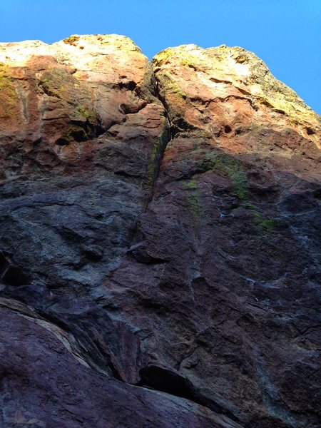 Follow bolts that trend right, then up the crack that splits the center of the wall.