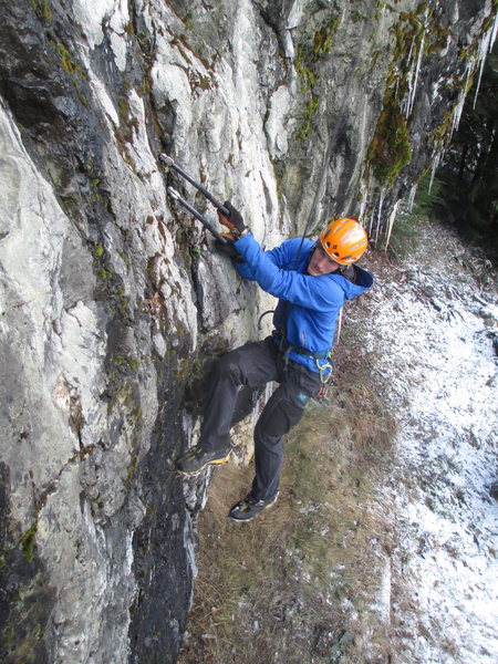 A climber working his way up the crack in the first third of the route.