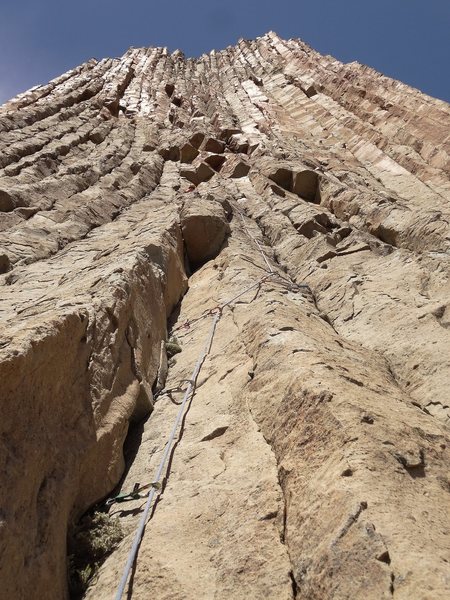 leaving the dihedral and going up between two pillars. Belay station on the top of the left pillar.