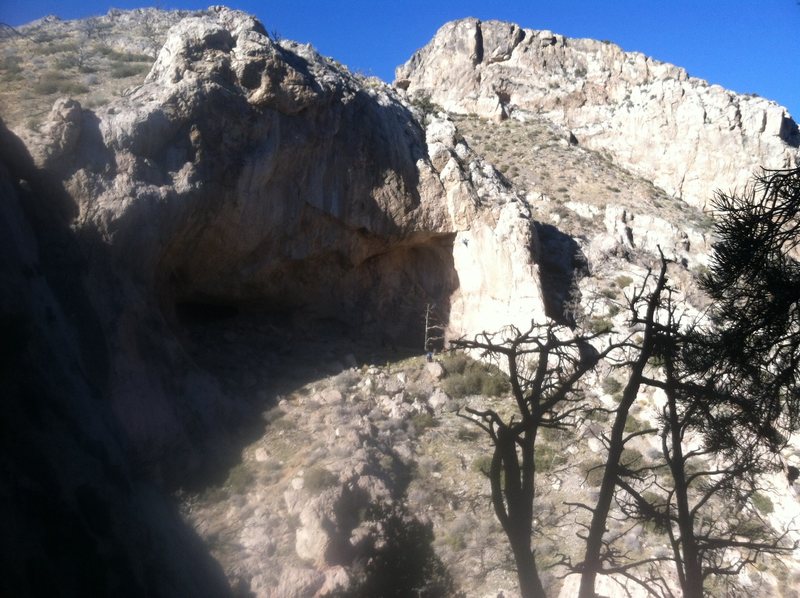 A climber on "fun pig" 13a in the sun on the right side of sunset cave