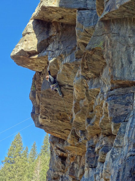 Liz moving fluidly through the crux roof.