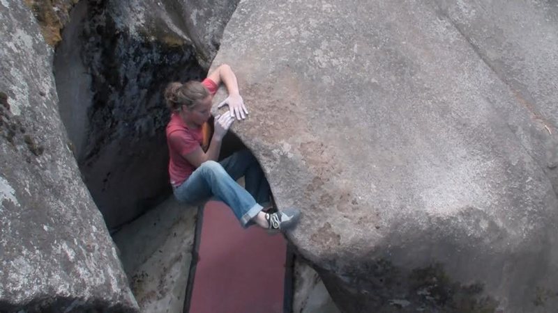 Jackie Hueftle at the mantle on the first ascent of Devet (V7/8) at The Grottos Day Use Area, The Ice Caves, Independence Pass, Colorado.