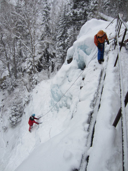 The belay is now second from left on the walkway (I think).