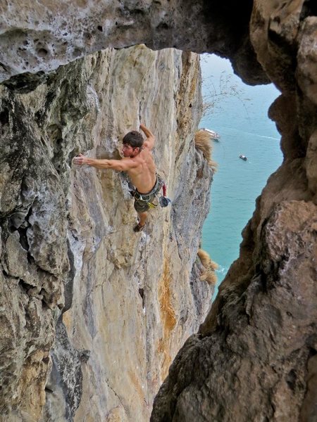 About to pull into the high crux. Just blew the flash on The King and I, 7a at Thaiwand Wall on West Railay Beach in Krabi, Thailand. Photo by Kira Krick.