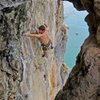About to pull into the high crux. Just blew the flash on The King and I, 7a at Thaiwand Wall on West Railay Beach in Krabi, Thailand. Photo by Kira Krick. 