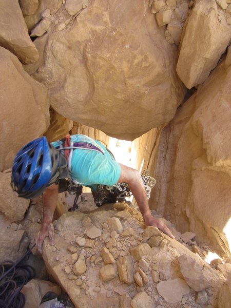 Gaining the chockstone at the top of pitch 2.