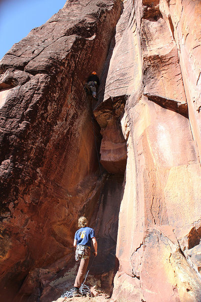 Dane Schellenberg above the roof and into the thin crack sequence on Wing and a Prayer Project