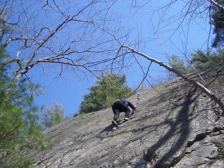 This slab is not mossy. It is 50 feet with a hand crack straight up the middle. It is located in section of forest over by the outlet mall.