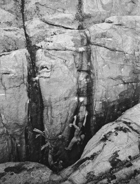 Mike Gasch climbing out of the chasm on the 2nd ascent of Voodoo Blues, 1999.
<br>
<br>
Wide Open Gasch V8-9 is the chalked line of crimps to his right. Black Magic is the streak to the left.