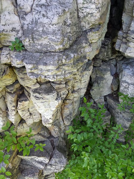 Arete under the nose with crack leading up under the gap between two ledges at the top of the climb