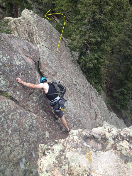 From the top, you can scramble north around where the arrow points, no downclimbing or rapping is necessary, just walk down the boulders to the ground.