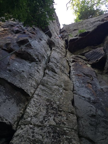 On top of the pillar where climbing transitions into the offwidth crack with some faceholds.