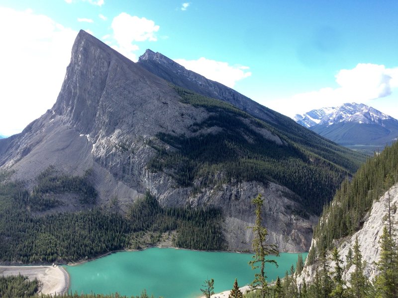 Ha Ling peak. The route follows the left side of the prominent face. The approach is up the scree field and follows the base of the cliff.