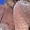 5.10 dihedral above Mount Elden pour off. 30 feet of clean fingers, and balancy undercling lead to a few stemming moves, and a sick overhanging/ heel hookin top out. Rap of of pinch. 