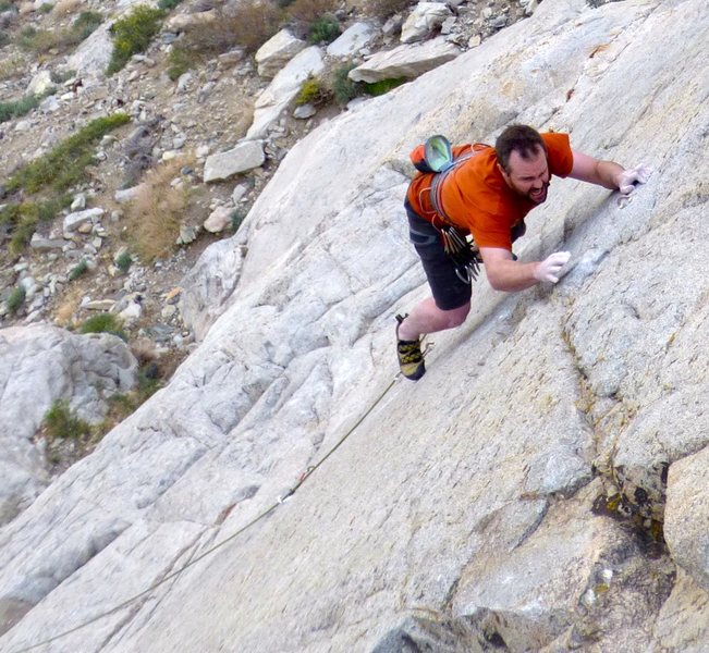 Trying hard to not whip off the crux on the first ascent.