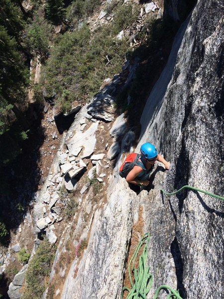 View from P1 belay. Route follows flake system down from climber and across 15ft ledge down another 50 foot crack system. P1: 5.7. roughly 110ft.