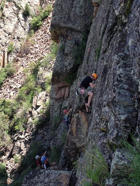 Some of the Upper Tier climbs from the west. The climber in the orange helmet is on Undisclosed Location. The climber in the red helmet beyond is on Three Little Bats.