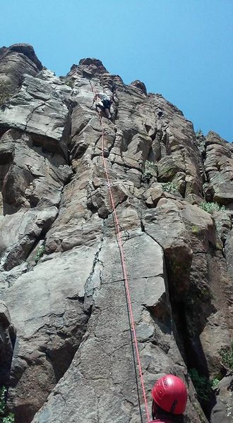 Belaying my son up the route.