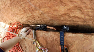 Belaying from the block right below the 4th pitch bolt that protects the traverse. You can see the yellow sling is backing up the #4 cam.