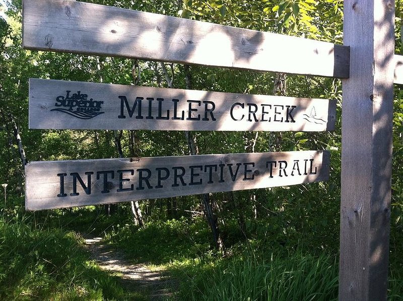 The sign for the interpretive trail, visible from the parking lot west of LSC