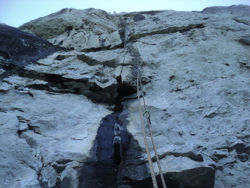 The often wet but rarely problematic "fin" hold that identifies the route.