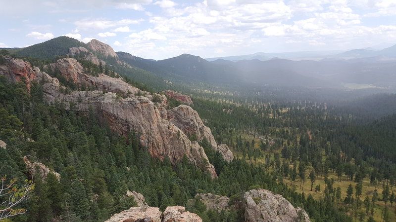 Summit of The Ranch Hand looking SE. The Dungeon is the large wall in the middle of the picture. Pike's Peak is partially obscured by rain in the upper right.