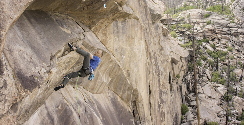 Mike Anderson climbing through the first part of the roof on The Legacy, 14a.