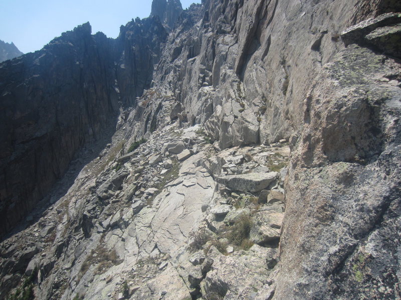 Looking back along the ridge, notice the shaded buttress on the left. Do NOT descend into the gully next to this thinking it is the way down. You need to go past this buttress on the top right side of it via a loose slot.