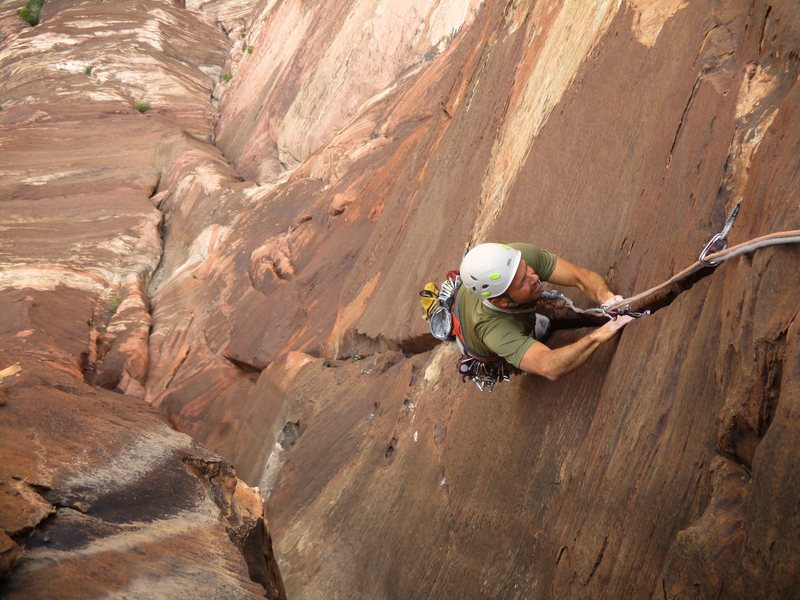 Kenny climbing up the 10b fingercrack on Pitch 4.