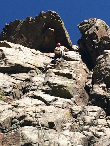 warming up on an easy trad route on the sports wall in clear creek.