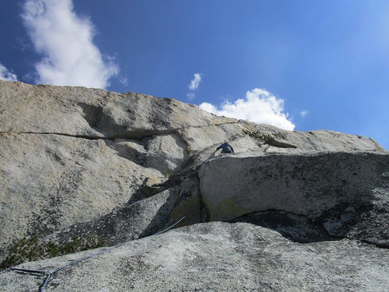 Tom Rogers starting the long traverse to the right, above the overhanging jam/lieback crack (5.10a) on Pitch 6 during the first ascent of Grand Central.