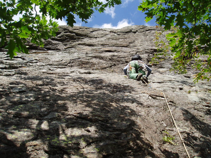 P2 - Climber is about to begin the traverse through the "Black Band". He is pretty much directly above the "ST". The "Rounded face" is a few feet left of the rope.
