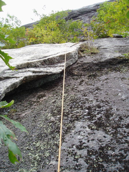 Looking up at the middle of P1 of the 1966 route, it climbs the easy flake.