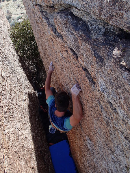 Between a boulder and a small crimp.