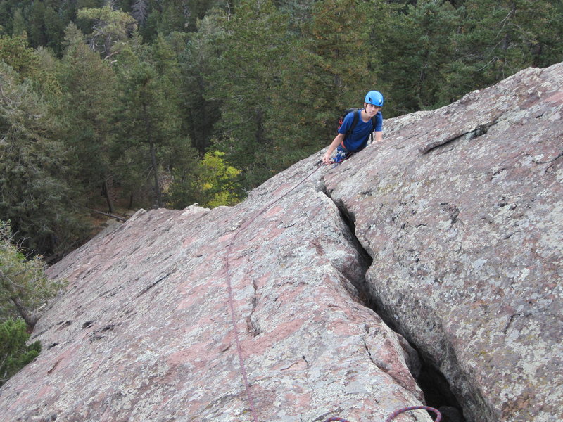 Looking down the first pitch. The crack in the foreground eventually delineates the arch.<br>
<br>
From this belay stance you can squeeze down through the crack and reach the underside of the arch and hiking territory. How do I know that? Because I did it in the opposite direction before the climb, we hiked up under the arch, and I squeezed through the crack and out onto the face, the exact spot I ended up belaying.