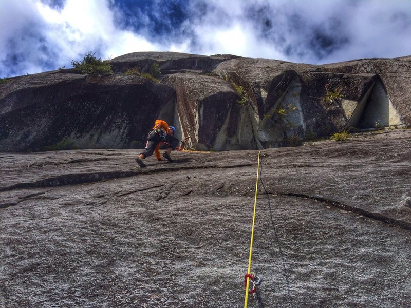 Ethan just past the crux while Chris belays from below the great arch.