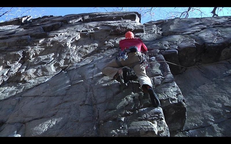 Ryan Webster traversing left out of the roof, about to enter the crux.