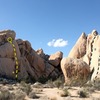 Southeast-facing cove around and right from Zinging in the Grain, Joshua Tree NP<br>
<br>
A. Phantom Tollbooth (5.10a)<br>
B. 30 Grit Route (5.6)<br>
C. The Grain Mutiny (5.3 R)