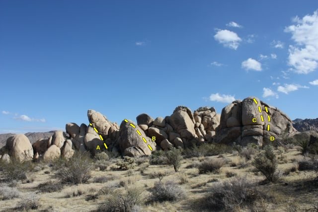 The north end of Grain Central Station, Joshua Tree NP<br>
<br>
A. Staircase Crack (5.4)<br>
B. B.M.T.C. Leader (5.7 R)<br>
C. Snoops (5.6)<br>
D. Dancing on Dimes (5.7)