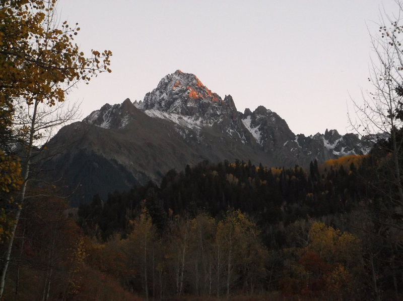 Last evening light on Sneffels as I push my bike up the gravel road toward Blue Lakes Hut