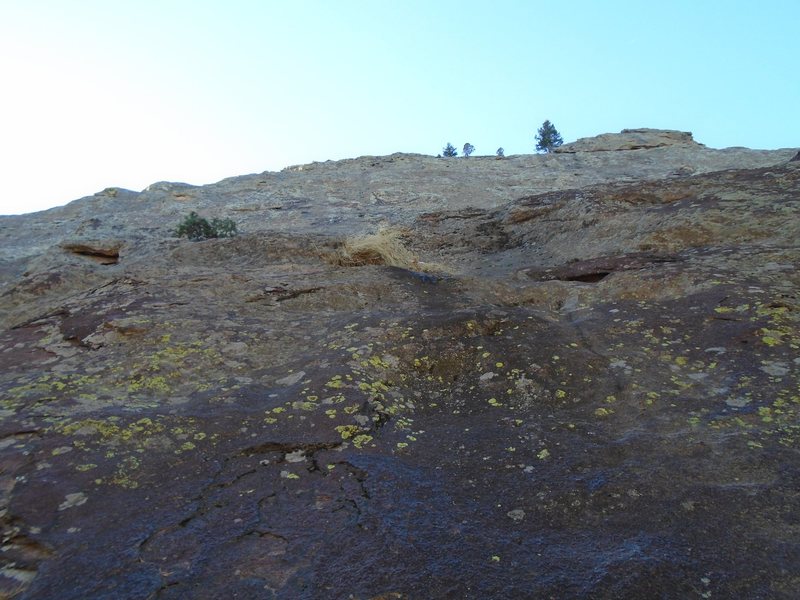 Looking up from where I started the route. I went up about 15 feet to a rail that I followed to my right. From there, I continued up and right until I was under the large buldge in the top right of the photo. You can do a really fun layback traverse clockwise around it and then continue up on easier climbing to the ridgeline.