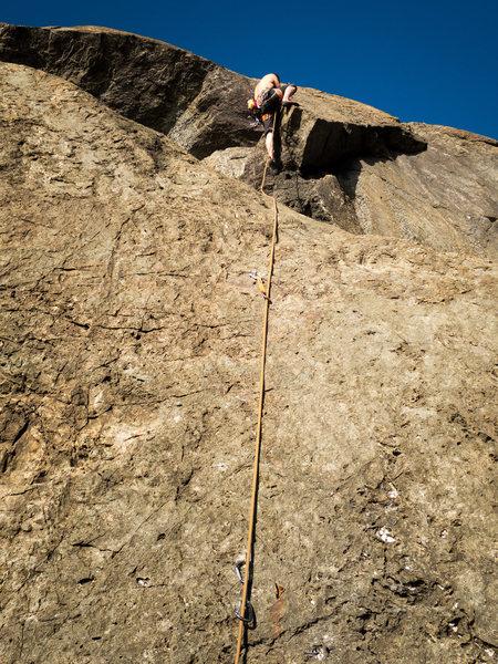 Ben pulling over the bulge at the 5th bolt.