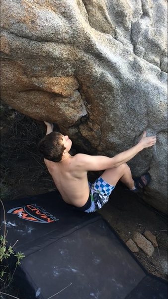 Starting move with left hand undercling in the cave, and right hand on the slopey sidepull.
