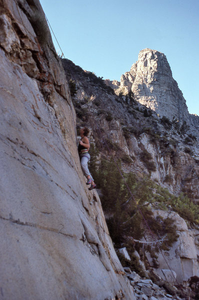 Urmas on "Girls On Fire" (5.11d) with the Sphinx formation in the background.
