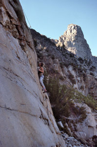 Urmas on "Girls On Fire" (5.11d) with the Sphinx formation in the background.