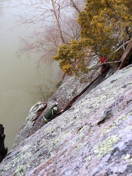 Looking down at the P2 belay. Chris downclimbing (aka down leading) P2.