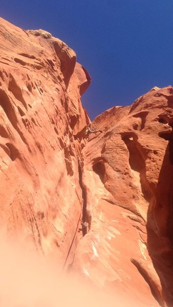 View from right the bottom belay ledge of 3rd pitch. Ethan is right below the 3rd roof, the crux.