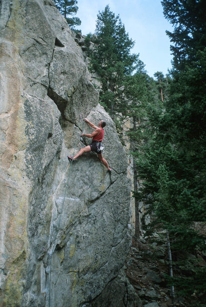 Steve Monks moving up and right, high on the route.