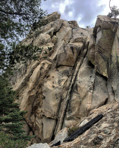 Follow dark rightward trending crack up into cave, then left from top of cave around block, then up.